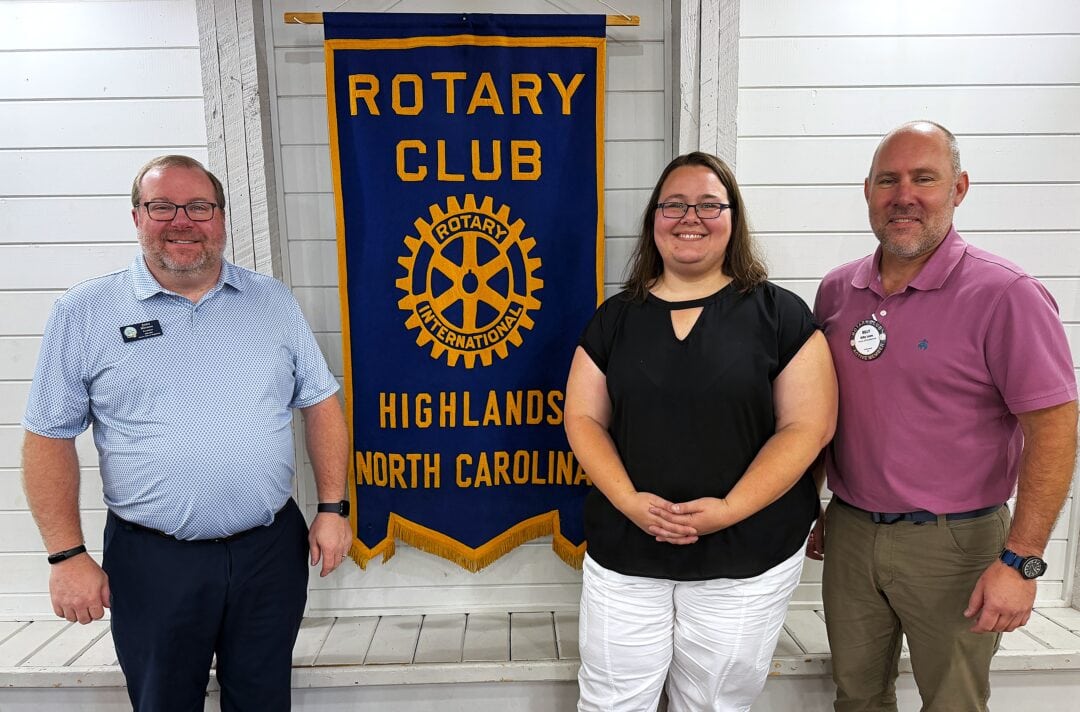 Danielle Hernandez standing between Rotary Club Cashiers members