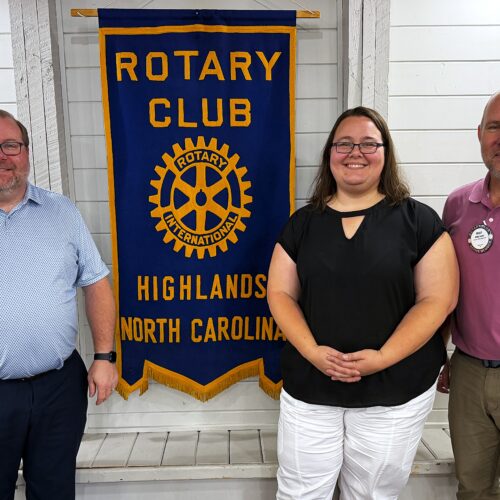 Danielle Hernandez standing between Rotary Club Cashiers members