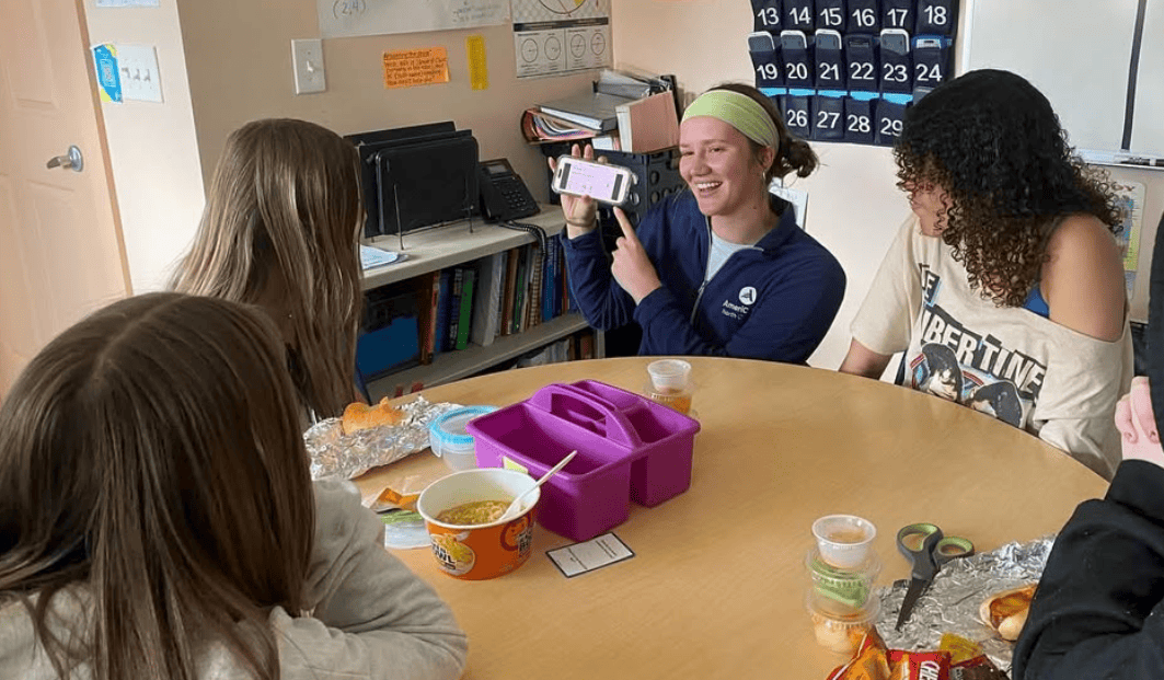 Project MARS members holding phone with students